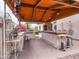 This outdoor kitchen has everything you need with a built-in grill, bar seating and covered dining area at 20439 E Palomino Dr, Queen Creek, AZ 85142