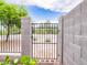 This gated side yard offers privacy and secure access with desert landscaping and block fencing at 20439 E Palomino Dr, Queen Creek, AZ 85142