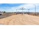 Will Rogers Equestrian Ranch entrance in Queen Creek with dirt, fencing, and facility in the background at 20439 E Palomino Dr, Queen Creek, AZ 85142