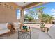 A relaxing outdoor patio features comfortable seating and a view of the sparkling pool at 21362 E Puesta Del Sol Rd, Queen Creek, AZ 85142