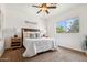 Bright bedroom featuring a ceiling fan, and a well-lit window offering pleasant outdoor views at 21362 E Puesta Del Sol Rd, Queen Creek, AZ 85142