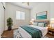 Comfortable bedroom features a ceiling fan, a bed with soft bedding and a bright, airy atmosphere at 21362 E Puesta Del Sol Rd, Queen Creek, AZ 85142