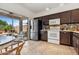Kitchen with stainless steel appliances, dark cabinets, and a view of the backyard patio at 21362 E Puesta Del Sol Rd, Queen Creek, AZ 85142