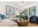 Bright living room featuring stylish decor, large windows, and a comfortable seating arrangement at 21362 E Puesta Del Sol Rd, Queen Creek, AZ 85142
