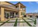Expansive backyard featuring a covered patio, outdoor seating, desert views and a modern turf and tile design at 21632 W Hillcrest Blvd, Buckeye, AZ 85396