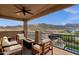 This cozy covered balcony features comfortable seating and a fire pit, perfect for enjoying views and relaxation at 21632 W Hillcrest Blvd, Buckeye, AZ 85396