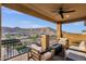 This cozy covered balcony features comfortable seating and a fire pit, perfect for enjoying sunset views and relaxation at 21632 W Hillcrest Blvd, Buckeye, AZ 85396