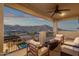 Balcony offers comfortable seating and a fire pit with views of the mountains, pool, and outdoor kitchen at 21632 W Hillcrest Blvd, Buckeye, AZ 85396