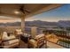 Serene balcony setting, showcasing comfortable outdoor seating and a fire pit, with expansive desert landscape views at 21632 W Hillcrest Blvd, Buckeye, AZ 85396