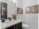 Stylish half bathroom with a modern vanity, marble countertop, and elegant decor at 21632 W Hillcrest Blvd, Buckeye, AZ 85396