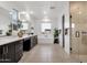 Bright bathroom featuring double sinks, a modern soaking tub, a glass shower, and large windows at 21632 W Hillcrest Blvd, Buckeye, AZ 85396