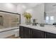 Well-lit bathroom featuring a tub, sleek vanity with modern fixtures, and a large mirror at 21632 W Hillcrest Blvd, Buckeye, AZ 85396