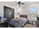 Comfortable bedroom with a ceiling fan, modern design, and a window offering natural light at 21632 W Hillcrest Blvd, Buckeye, AZ 85396