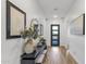 Bright entryway with a modern front door, stylish console table, and beautiful decor at 21632 W Hillcrest Blvd, Buckeye, AZ 85396