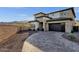 Front exterior of a two-story home featuring a modern design and desert landscaping at 21632 W Hillcrest Blvd, Buckeye, AZ 85396