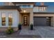 Charming front entrance with a modern door, desert landscaping, and a paved walkway at 21632 W Hillcrest Blvd, Buckeye, AZ 85396