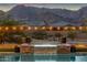 Hot tub with waterfall feature and decorative planters with mountain views in the background at 21632 W Hillcrest Blvd, Buckeye, AZ 85396
