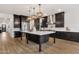Elegant kitchen featuring a large island, stainless steel appliances, and dark wood cabinetry at 21632 W Hillcrest Blvd, Buckeye, AZ 85396