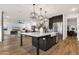 Bright, open kitchen with a large island, stainless steel appliances, and seamless flow to the living area at 21632 W Hillcrest Blvd, Buckeye, AZ 85396