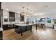 Spacious open-concept kitchen featuring a large island, dark cabinetry, and stainless steel appliances at 21632 W Hillcrest Blvd, Buckeye, AZ 85396