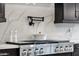 Close-up view of a gourmet kitchen featuring a stainless steel range and stylish backsplash at 21632 W Hillcrest Blvd, Buckeye, AZ 85396