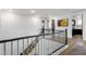 Second-floor landing featuring wood floors, metal railings and modern artwork at 21632 W Hillcrest Blvd, Buckeye, AZ 85396
