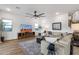 Open concept living room featuring neutral tones, wood floors and modern ceiling fan at 21632 W Hillcrest Blvd, Buckeye, AZ 85396