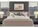 Close up of a king-size bed with gray and white pillows and lamps on the nightstands at 21632 W Hillcrest Blvd, Buckeye, AZ 85396