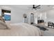 Bright main bedroom boasts a ceiling fan, dresser and a view of the mountains at 21632 W Hillcrest Blvd, Buckeye, AZ 85396