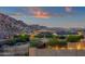 Scenic neighborhood view with desert landscaping and the city lights in the background at 21632 W Hillcrest Blvd, Buckeye, AZ 85396