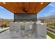 The outdoor kitchen is equipped with stainless steel appliances, a built-in grill, and plenty of counter space at 21632 W Hillcrest Blvd, Buckeye, AZ 85396