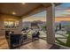 Inviting outdoor living space with comfortable seating, a pool, and stunning mountain views at sunset at 21632 W Hillcrest Blvd, Buckeye, AZ 85396