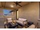 Cozy covered patio with comfortable seating around a modern fire pit, perfect for outdoor relaxation at 21632 W Hillcrest Blvd, Buckeye, AZ 85396