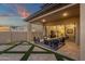 Covered patio area with stylish seating and sliding glass doors leading to an open-concept living space at 21632 W Hillcrest Blvd, Buckeye, AZ 85396