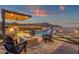 Beautiful backyard featuring pool, spa, built-in grill, and a cozy fire pit with mountain views at 21632 W Hillcrest Blvd, Buckeye, AZ 85396