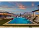 A backyard oasis featuring a pool, spa, and an elegant patio, perfect for outdoor relaxation at 21632 W Hillcrest Blvd, Buckeye, AZ 85396