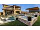 Inviting backyard pool and spa with outdoor seating and kitchen create a relaxing oasis for entertaining and enjoying the outdoors at 21632 W Hillcrest Blvd, Buckeye, AZ 85396