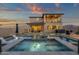 A pool and jacuzzi are surrounded by outdoor seating, with mountain views in the background at 21632 W Hillcrest Blvd, Buckeye, AZ 85396