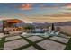 An outdoor pool area with built in grill and bar, pool, spa, and lounge chairs at 21632 W Hillcrest Blvd, Buckeye, AZ 85396