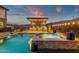 Luxurious backyard with a pool, spa, outdoor kitchen and bar area for entertaining at 21632 W Hillcrest Blvd, Buckeye, AZ 85396