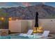Outdoor pool with lounge chairs in the water and mountain views at 21632 W Hillcrest Blvd, Buckeye, AZ 85396