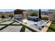 Relaxing backyard pool featuring a waterfall spa, in-pool loungers, and an outdoor kitchen for entertaining at 21632 W Hillcrest Blvd, Buckeye, AZ 85396