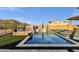 An inviting backyard pool with travertine surround, spa and mountain views create a relaxing oasis at 21632 W Hillcrest Blvd, Buckeye, AZ 85396