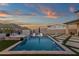 A beautiful pool and spa in an outdoor area, with lounge chairs and mountain views at 21632 W Hillcrest Blvd, Buckeye, AZ 85396
