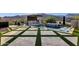 Backyard oasis with a pool, waterfall, outdoor kitchen, and meticulously designed travertine and turf at 21632 W Hillcrest Blvd, Buckeye, AZ 85396