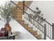 Elegant staircase with wood steps, metal railings and decorative plants at 21632 W Hillcrest Blvd, Buckeye, AZ 85396