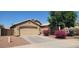 Attractive one-story home featuring a two-car garage, neat landscaping, and flowering bushes for added curb appeal at 2202 S 82Nd Ave, Phoenix, AZ 85043