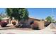 Charming single-Gathering home with a well-maintained front yard featuring colorful bushes and a mature tree at 2202 S 82Nd Ave, Phoenix, AZ 85043