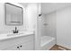 Bright bathroom featuring a stylish vanity, tub and tile walls at 2241 N Nicklaus Dr, Mesa, AZ 85215