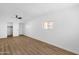 The light-filled bedroom boasts wood-look floors and a closet at 2241 N Nicklaus Dr, Mesa, AZ 85215